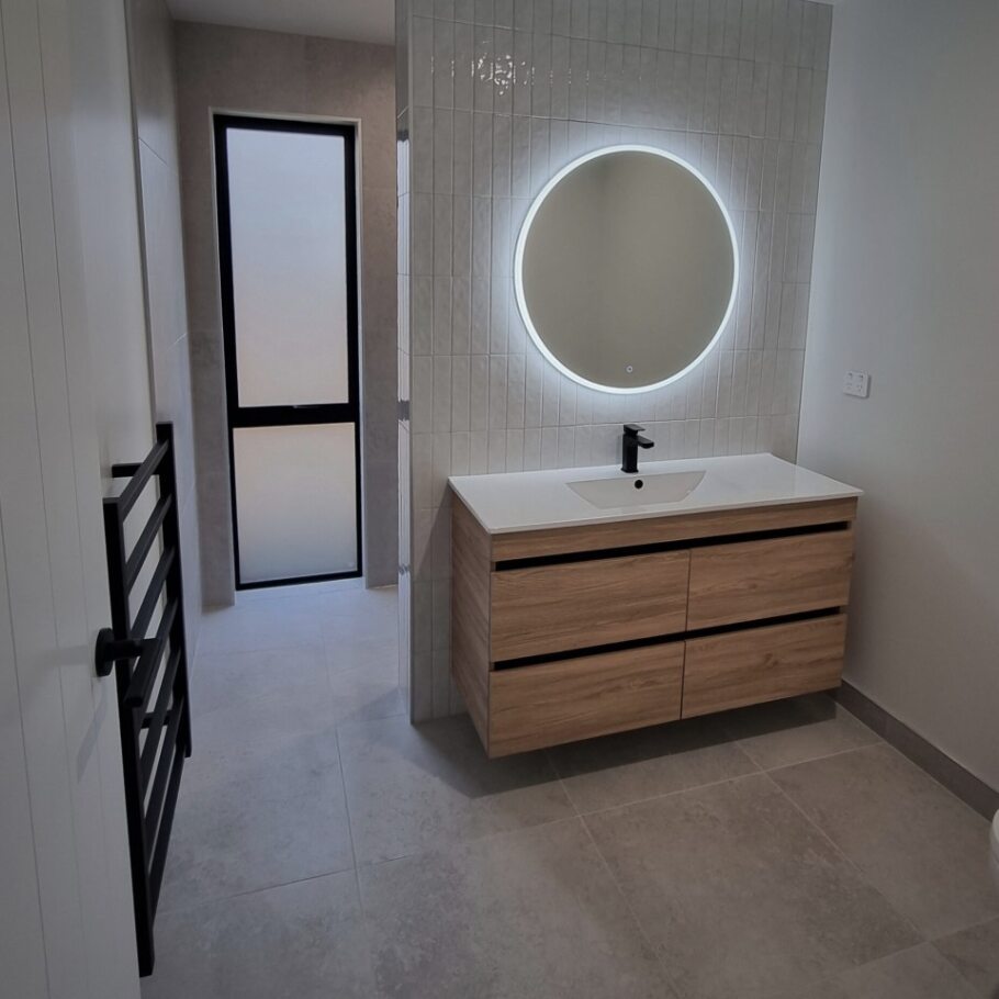 stunning circle mirror in bathroom of new build home at paerata rise